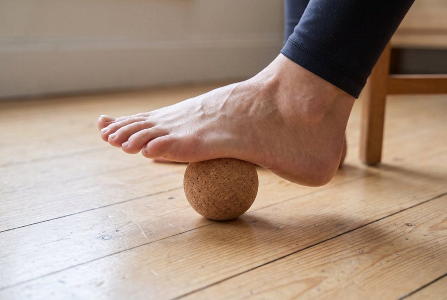 Rolling the sole of the foot over a cork massage ball